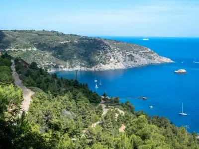 Panoramic view of the Magnet mount, a magnetite deposit where the famous iron mines of Elba island are located with yacht and sailboats on the fresh blue waters