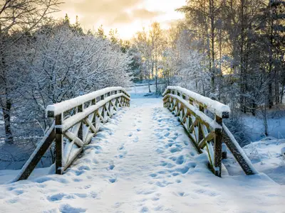 Snowy, wooden bridge in a winter day. Stare Juchy, Poland