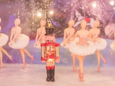 Christmas nutcracker toy soldier and balerina dolls on the stage. Famous Russian Ballet installation.