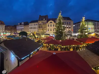 Gottingen, Germany. Christmas market at Market Square in dusk. Panoramic view from Old Town Hall.