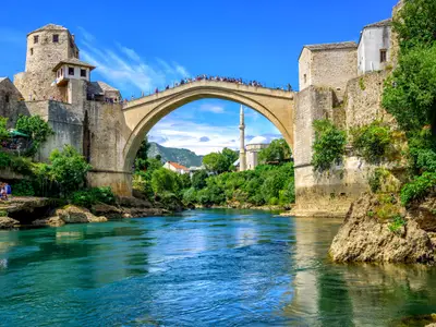 Historical Stari Most (Old Bridge) and Koski Mehmed Mosque in the Old Town Mostar on Neretva River, Bosnia and Herzegovina
