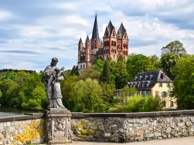 The Catholic Cathedral of Limburg at the river Lahn (German: Dom zu Limburg), Germany, viewed from the old Lahn bridge with a statue of Saint John of Nepomuk.