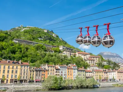 GRENOBLE, FRANCE - APRIL 13 : Grenoble-Bastille cable car, four bubbles on sling, transport to hill and fortress of Bastille cross Isere river in Grenoble, France, was taken on April 13, 2017.