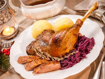 Crusty Christmas goose leg with braised red cabbage and dumplings