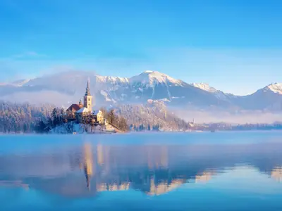Lake bled on a winter sunny morning with clear sky and snow covering the mountains