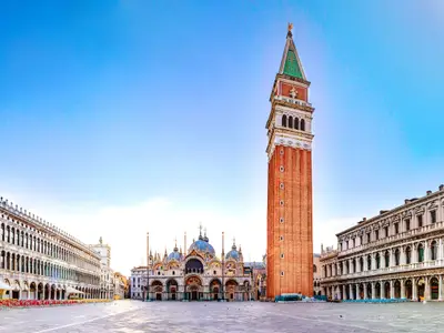 Sunrise in San Marco square with Campanile and San Marco's Basilica. Panorama of the main square of the Old town. Venice, Veneto, Italy.