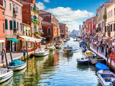 Island murano in Venice Italy. View on canal with boat and motorboat water. Picturesque landscape.