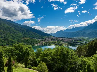 Aerial view of the small town of Levico Terme with the lake (Lago di Levico) and the mountains, Alps. Trentino Alto Adige, Italy, Europe
