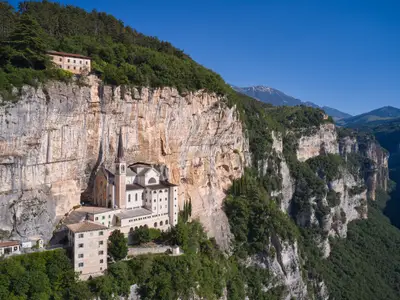 Church in the rock, Santuario della Madonna della Corona. Madonna della Corona Sanctuary view, surrounded by mountains. An old church, built around 1625, on a quiet, picturesque mountainside.