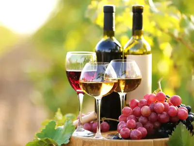 Tasty wine on wooden barrel on grape plantation background