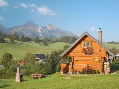 Panorama of Belianske Tatry mountains and the little blockhouse in Zdiar village.