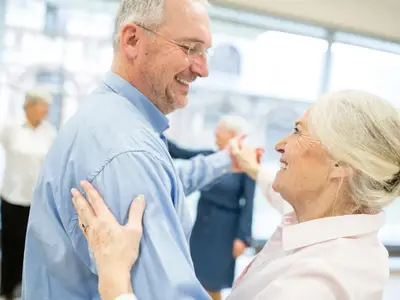 Group of active senior attending dance course in retirement home