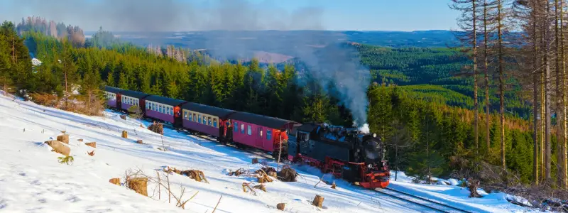 Steam train during winter in the snow in the Harz national park Germany,train Brocken Bahn on the way through the winter landscape, Brocken, Harz Germany