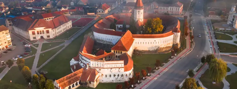 Prejmer, Romania. Aerial view of fortified church powerful thick walls in Transylvania, autumn misty morning.