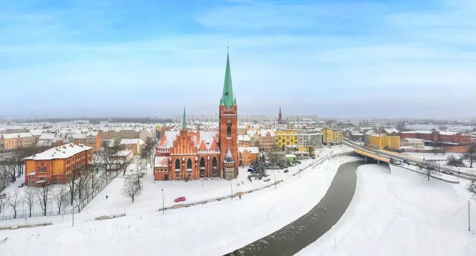 Legnica, Poland. Panoramic aerial winter cityscape with Saint Jack Sanctuary and Kaczawa river