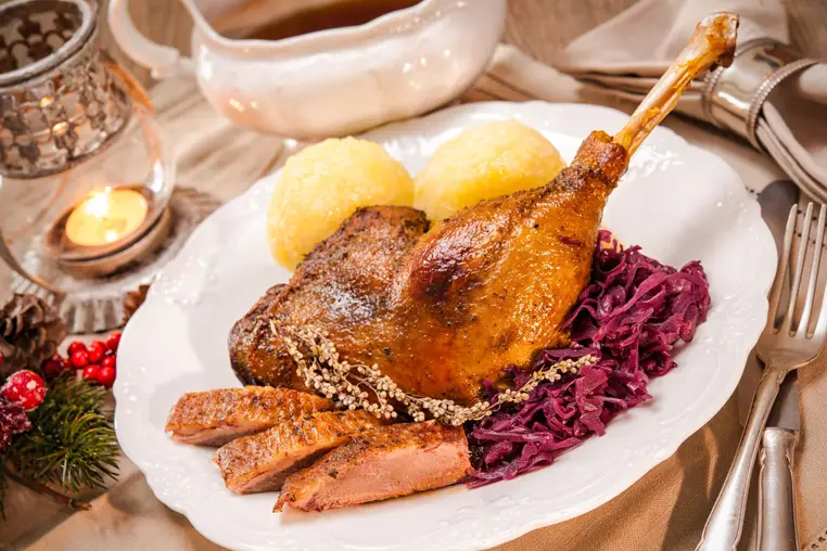 Crusty Christmas goose leg with braised red cabbage and dumplings